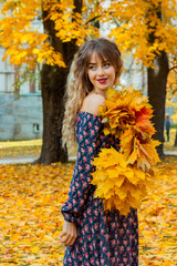 Beautiful girl with autumn leaves. October photos of autumn.