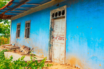 Facade of ruined and abandoned rustic house 