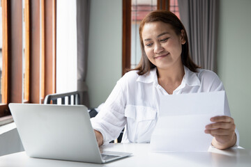 asian middle aged woman working from home