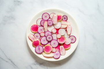 Fresh radishes on a white plate