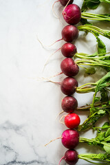 Fresh radishes on a marble surface