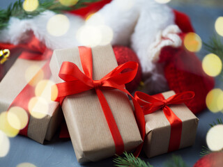 Close-up of Christmas gifts in a Santa Claus hat