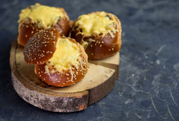 Julienne in a bun with a cheese cap on the table