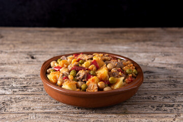 Ropa vieja food in bowl on rustic wooden table	