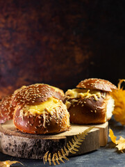 Julienne in a bun with a cheese cap on the table