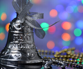 Silver bell on a Christmas background.