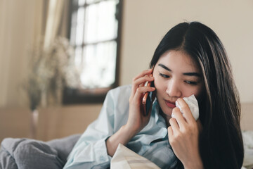 Young adult lonely single woman using smartphone in the moring for talking app with friend for...