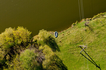 Top view of lonely rubber inflatable boat near the shore.