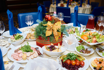 Table setting with white plates , blue serviettes and cutlery on table, copy space. Place setting at Christmas party. Table served for New year banquet in restaurant