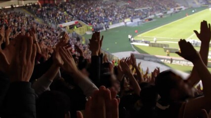 Fans cheering and supporting their football club at the championship match in the stadim on a sunny day - Powered by Adobe