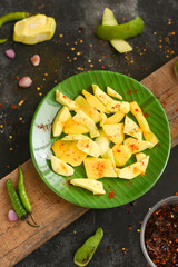 Sliced green mango with chili powder , salt street food snack Kerala. Organic Fresh mango table...