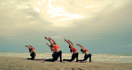 Professional group females yoga practice in class on mat stretching