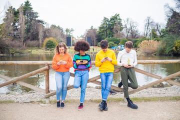 Group of multiethnic friends millennials using mobile phones