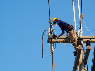 electrician man working at height and dangerous ,high voltage power line maintenance