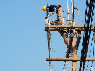 electrician man working at height and dangerous ,high voltage power line maintenance