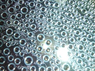 Small drops of condensation on a transparent plastic lid close-up.