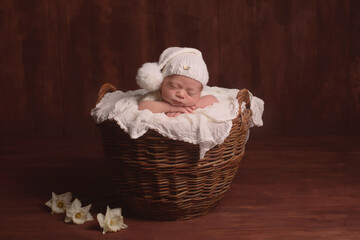 Obraz premium Cute infant Newborn baby in a knitted hat on a blanket. Portrait of newborn baby. Face of sleeping small child 
