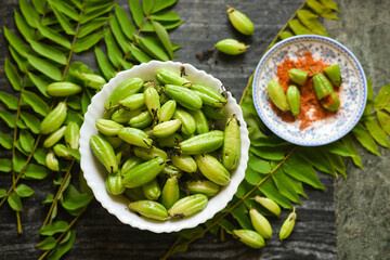 Belimbing sayur , Averrhoa bilimbi fruit with chilli powder, salt sour taste used as a spice in cooking , a mixture of herbal concoctions Kerala, India. Malabar Tamarind , Kudampuli Irumban Puli.