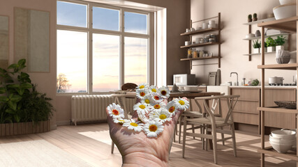 Woman's hand holding daisies, spring and flowers idea, over country rustic wooden kitchen with dining table, shelves with appliances and potted plants, decors, interior design concept