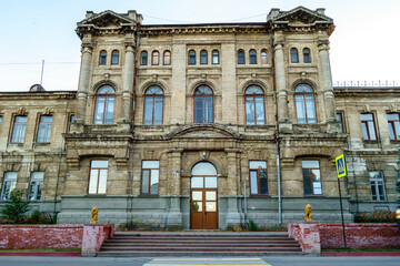 Fototapeta na wymiar Facade of Romanov women's gymnasium in Kerch, Crimea. School was built in honor of Russian Tsar's family. Now it's one of most attractive old buildings in city