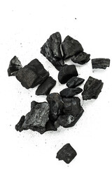 Many pieces of black charcoal isolated on white background.