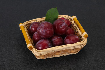Plum heap in the wooden basket