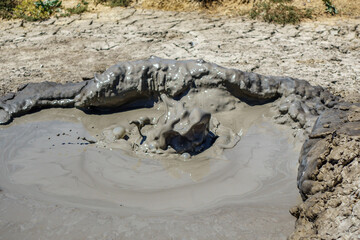 Splashes of exploded gas bubble inside crater of mud volcano. Shot in Bulganak field, near Kerch, Crimea