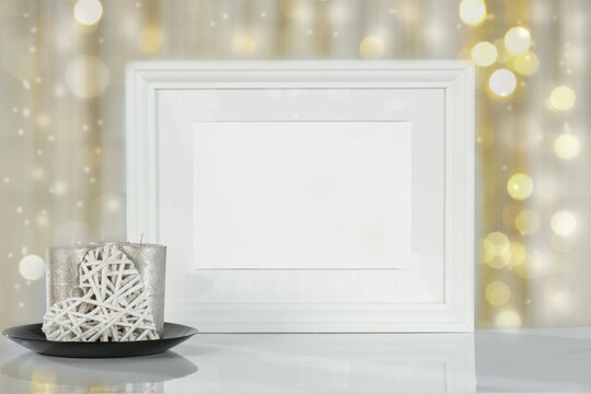 White frame with a free background on a wooden table on a festive day