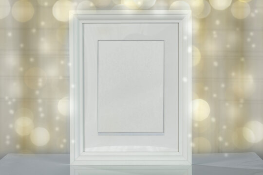 White frame with a free background on a wooden table on a festive day