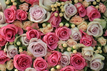 Pink and purple roses in a wedding centerpiece