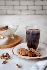 Cosy homemade oatmeal cookies and a cup of coffee.