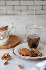 Cosy homemade oatmeal cookies and a cup of tea.