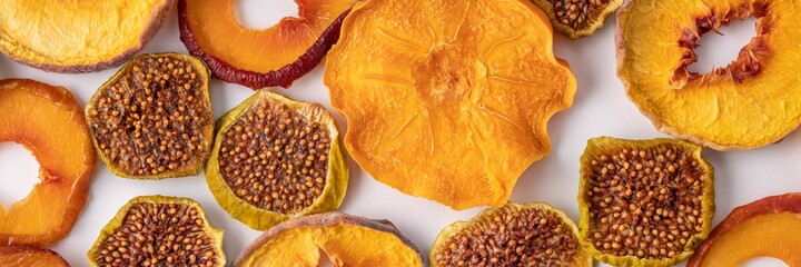 slices of dried persimmon, peach, plum and figs on a white background. dried fruits. eco.