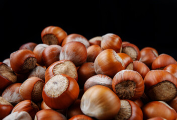 Hazelnut slide. Solid ripe hazelnuts on a black background.