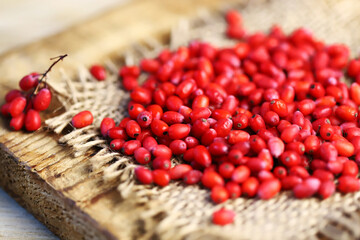 Fresh berries of barberry on a wooden surface.