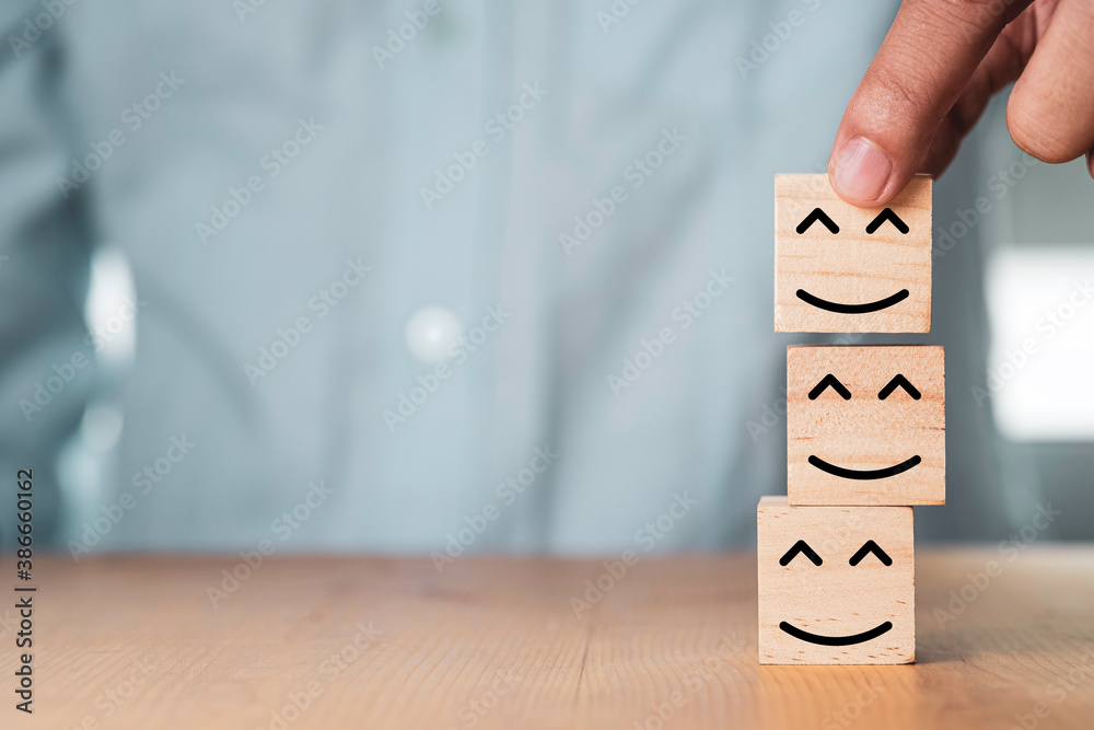 Poster select emotion or mood concept , hand holding and stacking smile face or happy face which print scre