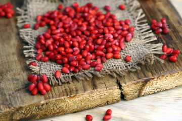 Fresh berries of barberry on a wooden surface.