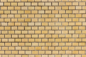Fototapeta premium Surface of a yellow brick wall.