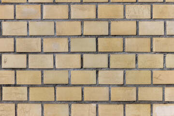 Surface of a yellow brick wall.