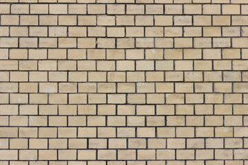 Obraz premium Surface of a yellow brick wall.