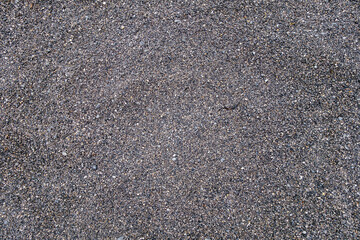 View from top onto surface of coastline covered by very small pebbles