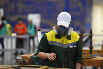 people in masks are working on projects indoors