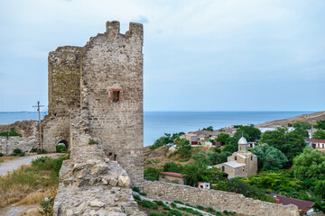 Fototapeta na wymiar Panorama from medieval walls of Genoese fortress, Feodosia, Crimea. There are one of its towers, church of St. John The Baptist & Black Sea (on distant background)
