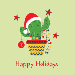 Christmas card with funny cactus in santa red hat