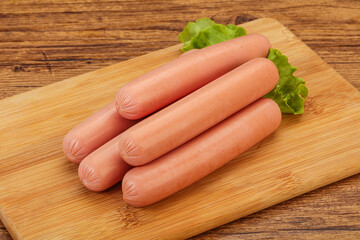 Tasty meat sausages over board