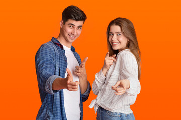 Funny lucky millennial man and woman point fingers at camera and rejoice to success after win at good day