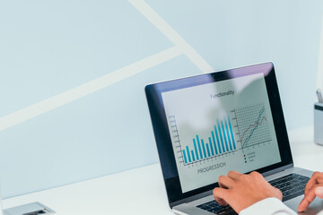 businessman works using a laptop to analyze financial data .