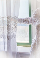 Bride looking out window