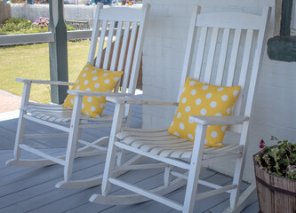 Rocking chairs with yellow polka dot pillows