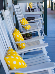 Rocking chairs with yellow polka dot pillows